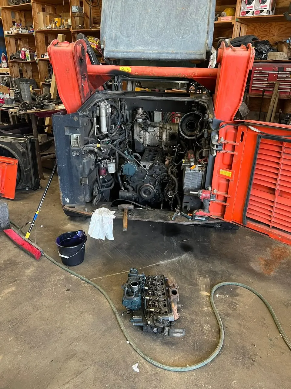 Skid steer with engine pulled and injection pump out for rebuild